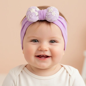 Close-up of purple elastic baby headband with white flower embroidery on padded bow