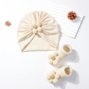 Newborn cream ribbed knit beanie and socks set with wooden bead flower decor