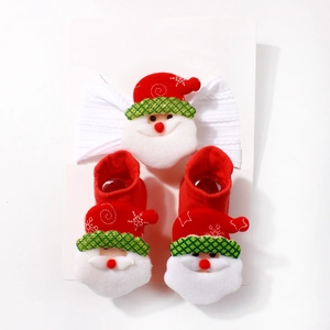 Detail of Christmas baby set including Santa bow headband and knit socks with snowflake embroidery