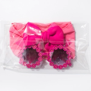 Detail view of baby fashion set with rose red bow headband and daisy round sunglasses