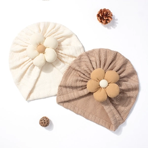 Baby knit turban hat with corduroy flower detail in soft beige and brown colors