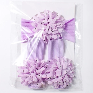 Detail view of light purple baby headband and socks set with large floral fabric ornaments