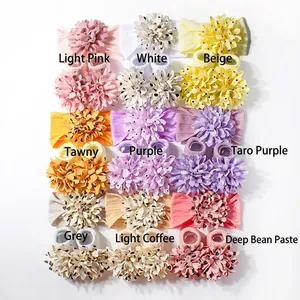 Flat lay of floral baby headband and sock sets in nine assorted soft pastel colors