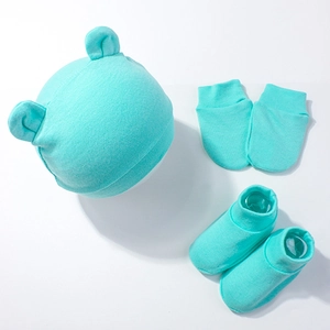 Detail view of mint green newborn baby beanie with bear ears, mittens, and booties set