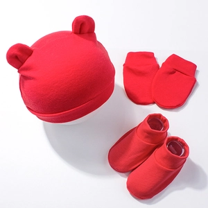 Detailed view of red newborn knit set with bear ear hat, mittens and booties