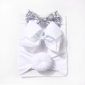 Detailed set of three white baby headbands with silver sequins and soft fabric bows