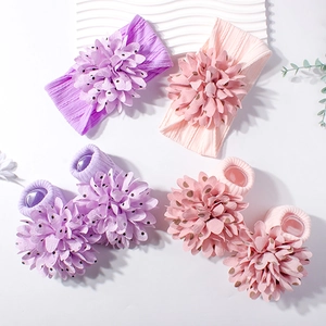 Baby flower headband and sock set in pastel colors with 3D floral accents on white background