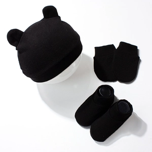 Detailed view of 3-piece newborn set with bear ear knit hat, mittens and socks in black