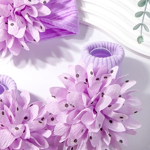 Detail of purple baby headband and socks set with large polka dot fabric flowers