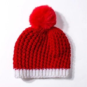 Winter baby knit hat with red and white patterns and a fluffy faux fur pompom decoration