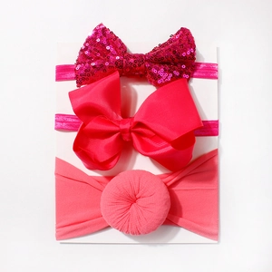 Detailed view of three-piece baby headband set with sequins, ribbed bows and soft fabric knot