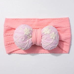 Detailed embroidery on soft lilac bow with jacquard floral patterns for baby headband