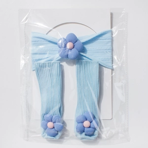 Detail of ribbed knit baby headband and socks set with 3D purple flower appliques