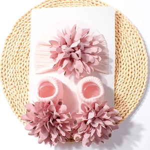 Pink floral baby headband and socks set with polka dot petal patterns on soft knit fabric