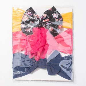 Three-piece baby headband set featuring large floral bows and a 3D pink fabric flower