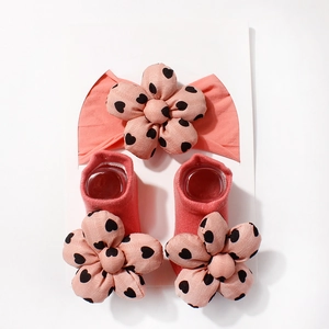 Detail von korallenrosa Baby-Stirnband und Socken-Set mit 3D-Herz-Blumenapplikationen