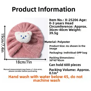 Detail view of pink plush baby turban with bear patch showing product size measurements