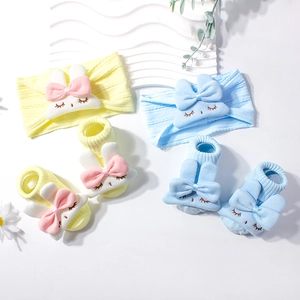 Baby headband and socks set in soft yellow and blue with cute bunny patterns