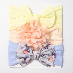 Three-piece baby headband set with bows and flowers in yellow, pink, and purple colors