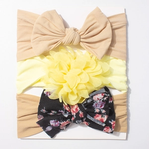 Three-piece baby headband set with soft beige bow, yellow flower, and floral patterns