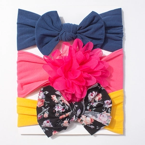 Three-piece baby headband set featuring bow and floral designs in soft fabric