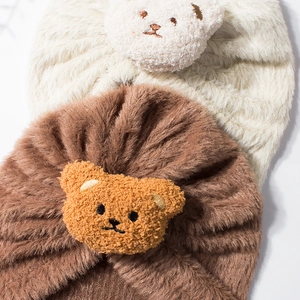 Detail of plush baby hats in beige and brown with cute 3D embroidered bear ears