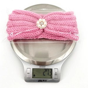 Pink knitted baby headband featuring a pearl and rhinestone center ornament weighing 27.3g