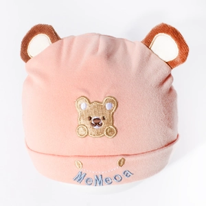 Detail of pink cotton baby hat with 3D bear ears and intricate embroidery texture