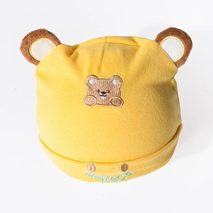Detail of yellow cotton newborn hat featuring cute bear ears and delicate bear embroidery