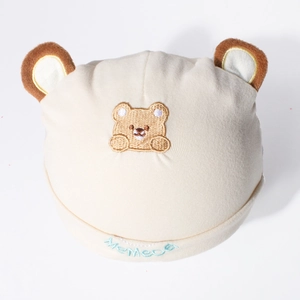Close-up of baby bear beanie with brown plush ears and MeMeCa embroidery detail