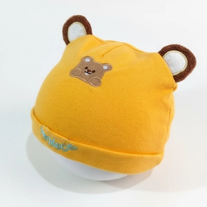 Detailed view of ginger baby knit hat with bear ears and MeMeoo embroidery detail
