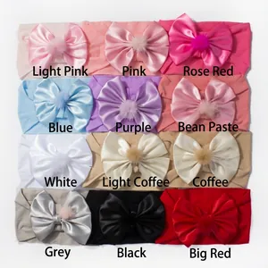 Detail display of 12 colors elastic nylon headbands with ribbon bows and pompoms for babies