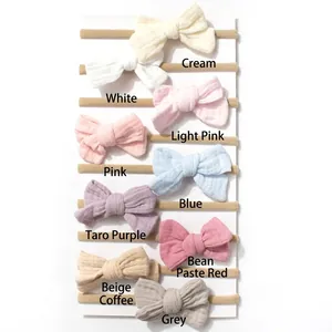 Vertical display of multi-colored nylon baby headbands with soft fabric bow details