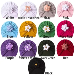 Soft baby knit turban hats with floral decor in multiple colors for winter warmth
