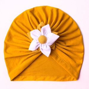 Infant winter turban hat in mustard yellow with a large decorative white fabric flower