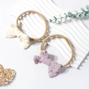 Elastic baby headbands with cotton bows in beige and lilac, two-piece set for newborns