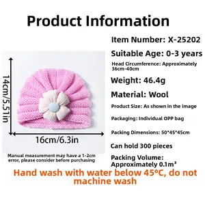 Pink knit baby beanie with floral detail showing dimensions 14x16cm for ages 0-3 years