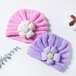 Cute striped knitted baby turban hats with large fabric flowers in pink and purple