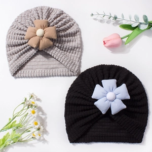 Baby turban hat with ribbed knit fabric and large decorative flower in grey and black