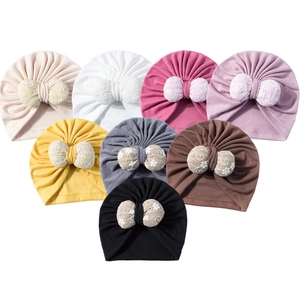 Eight colors of floral bow baby beanies including beige, purple, and yellow