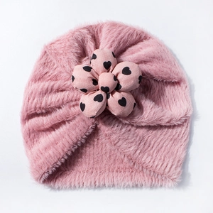 Dettaglio del cappello turban neonato in morbido peluche con fiore a cuori