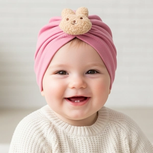 Pink infant knot turban hat with a cute plush bear detail for warm baby headwear