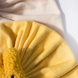 Detailed view of soft brushed knit fabric and layered pleats on baby warm winter hat