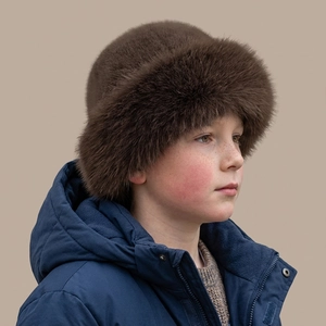 Side view of a dark brown faux fur Mongolian winter hat featuring a fluffy brim for warmth