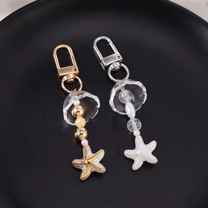 Porte-clés perlés en forme d'étoile or et argent avec pendentifs étoile de mer