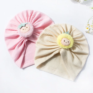 Cute waffle-knit baby turban hats with smiling plush balls and soft ribbed fabric texture