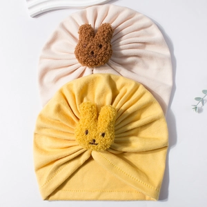 Soft knit baby turban hats with cute plush bunny decor in light pink and bright yellow