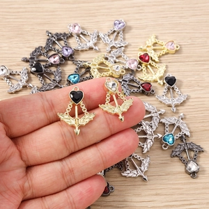 Macro shot of colorful heart cupid arrow pendants for DIY jewelry making