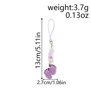 Detailed view of purple paw pendant phone charm with dimensions and weight metrics