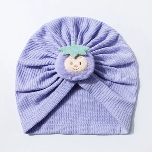 Detail of lavender waffle knit baby turban hat with cute plush smile face embroidery